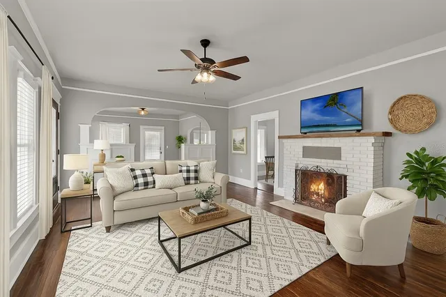 a living room with furniture and a fireplace