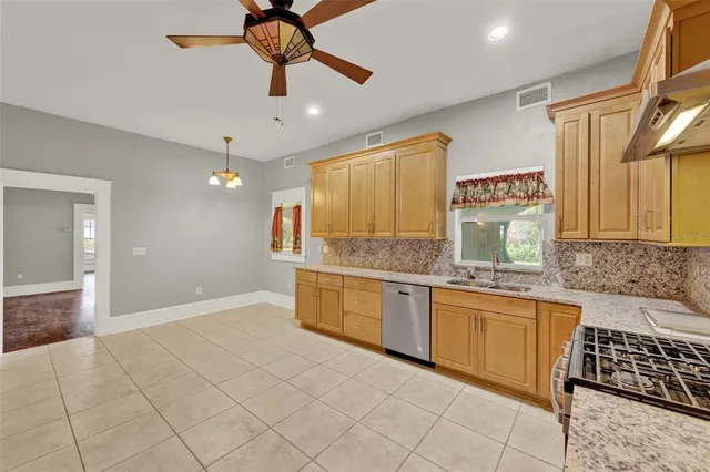 a kitchen with stainless steel appliances granite countertop a sink and cabinets
