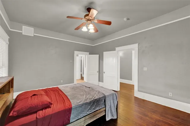 a bedroom with a bed and a chandelier
