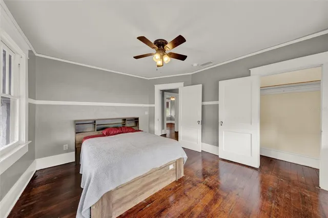 a bedroom with a bed and a chandelier