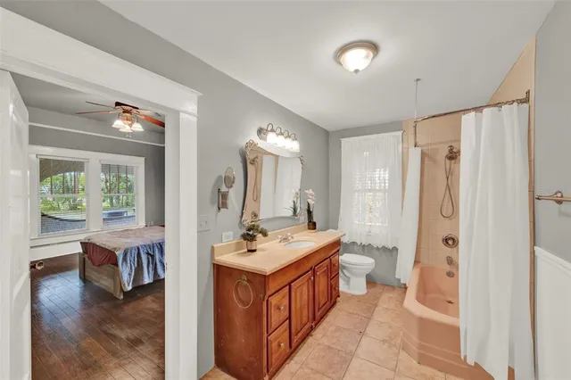 a bathroom with a sink a toilet and a mirror
