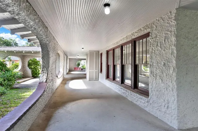 a view of a porch with furniture and garden