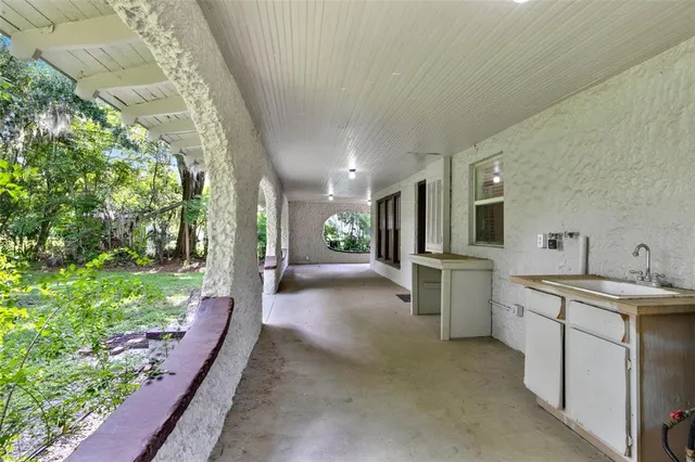 a view of a kitchen with a sink and dishwasher with wooden floor