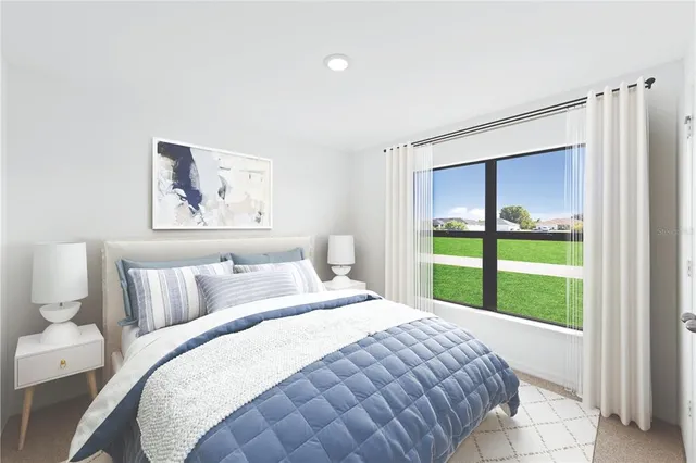 a bedroom with a bed and a large window