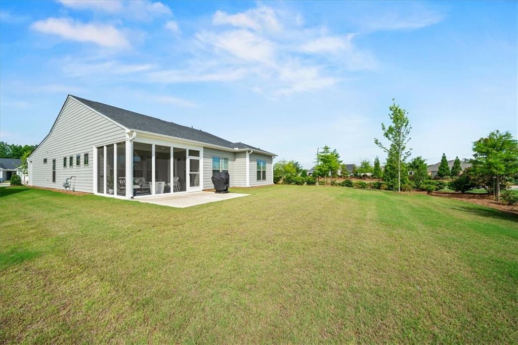 2457 Naples Street Hoschton, GA 30548 - Photo 36 of 41 a front view of house with yard and trees in the background