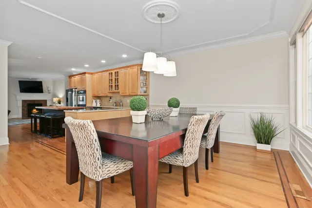 a dining room with furniture and wooden floor