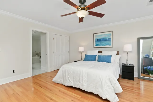 a bedroom with a large bed and a chandelier
