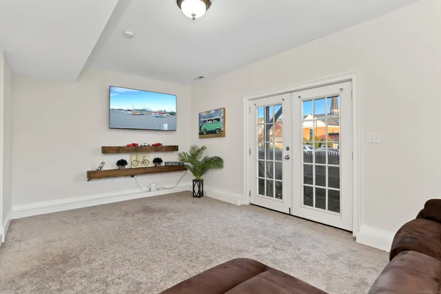 a view of an empty room with furniture and window