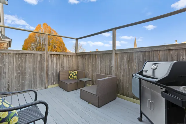 a backyard of a house with sofas fire pit and furniture