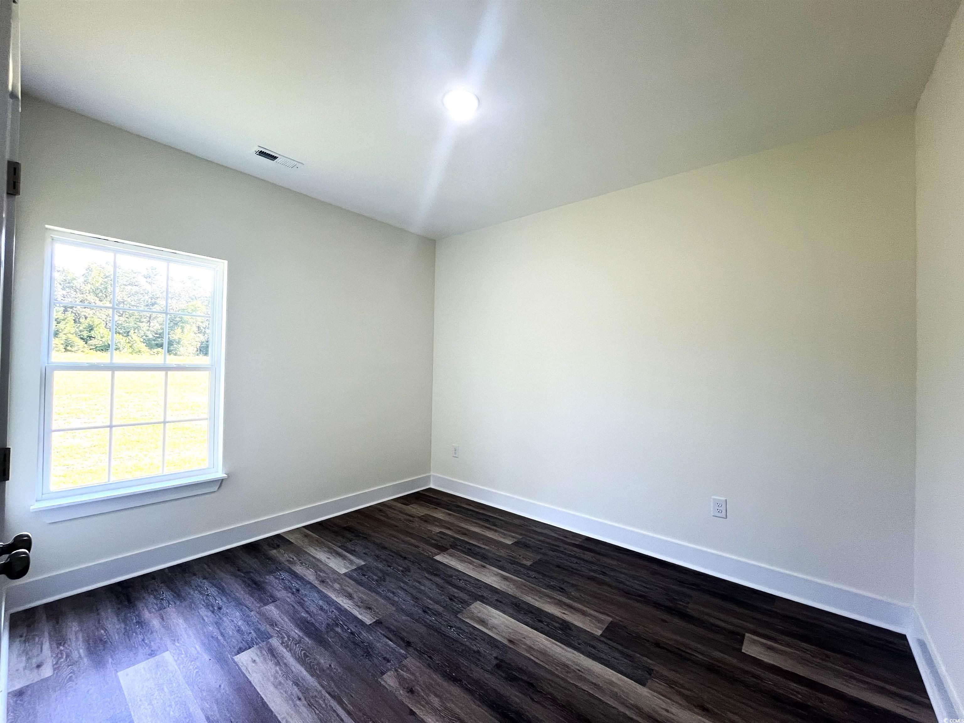 1226 St John Road Galivants Ferry, SC 29544 - Photo 13 of 21 Empty room featuring dark wood finished floors and baseboards
