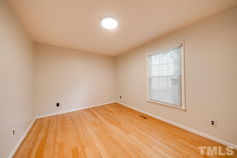 2349 Florida Court Raleigh, NC 27615 - Photo 14 of 19 a view of empty room with wooden floor