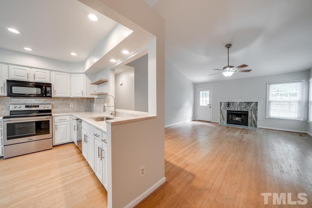 2349 Florida Court Raleigh, NC 27615 - Photo 3 of 19 a kitchen with granite countertop a stove top oven and cabinets