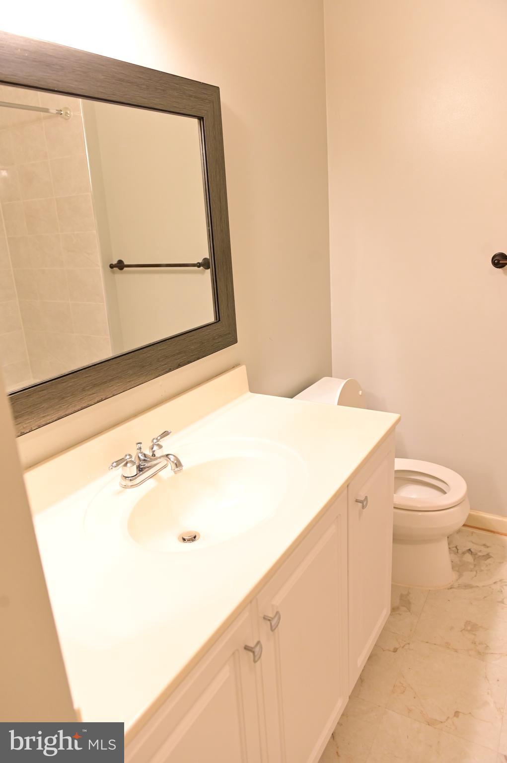 8635 Jacks Reef Road Laurel, MD 20724 - Photo 16 of 49 a bathroom with a toilet sink and vanity