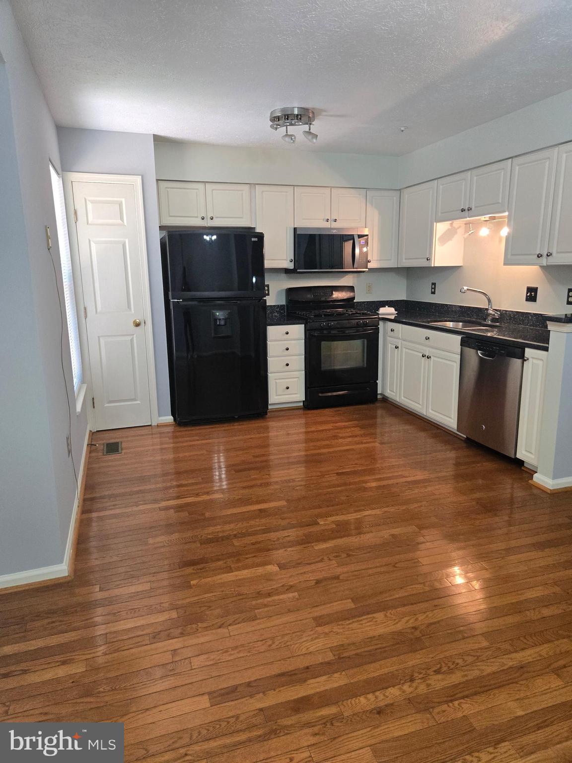 8635 Jacks Reef Road Laurel, MD 20724 - Photo 47 of 49 a large kitchen with stainless steel appliances granite countertop a refrigerator and a stove