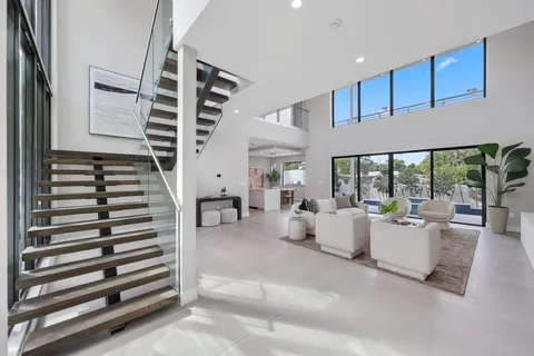 a living room with furniture and stairs