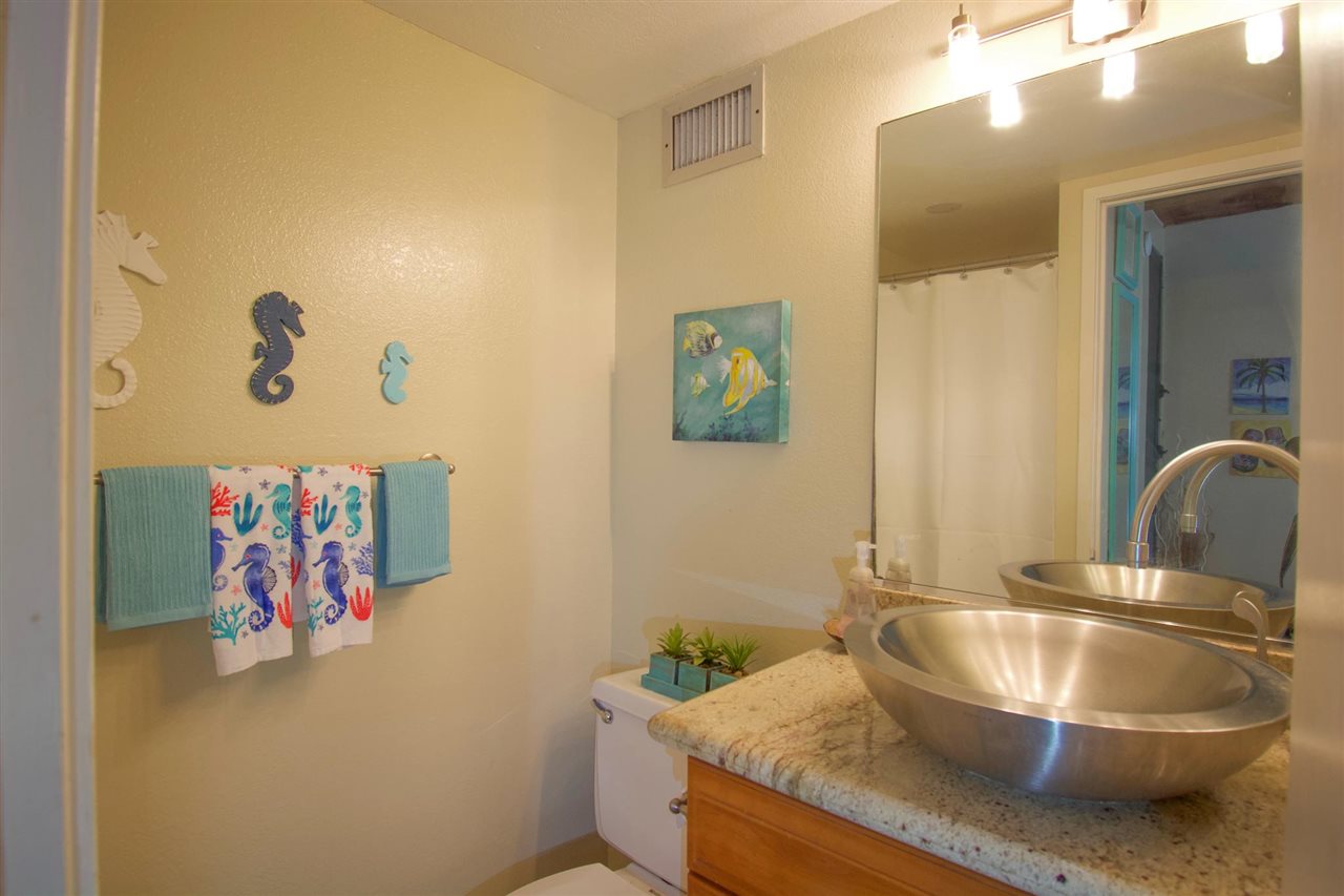 2191 South Kihei Road, Unit 3419 Kihei, HI 96753 - Photo 15 of 30 a bathroom with a granite countertop sink a mirror and vanity