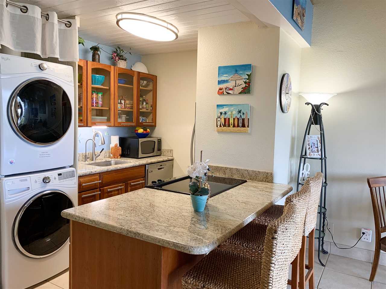 2191 South Kihei Road, Unit 3419 Kihei, HI 96753 - Photo 18 of 30 a view of a kitchen with granite countertop a sink a stove and wooden floor