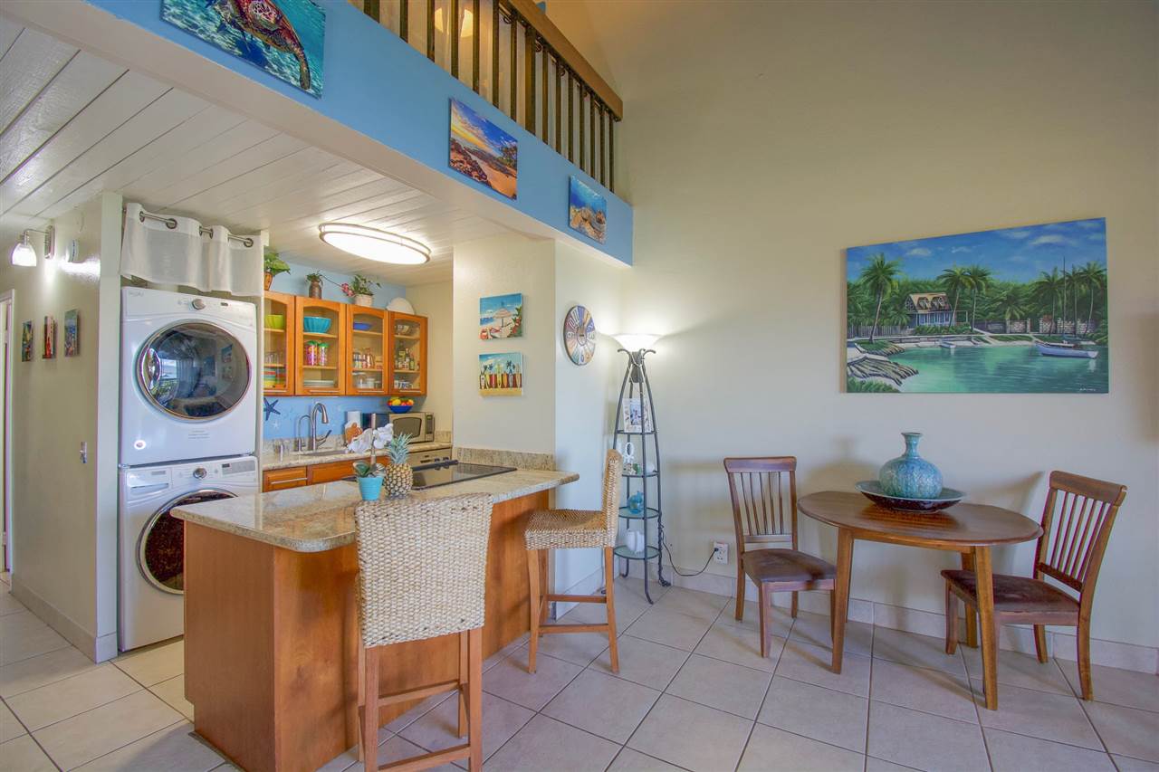 2191 South Kihei Road, Unit 3419 Kihei, HI 96753 - Photo 20 of 30 a dining room with furniture and chandelier