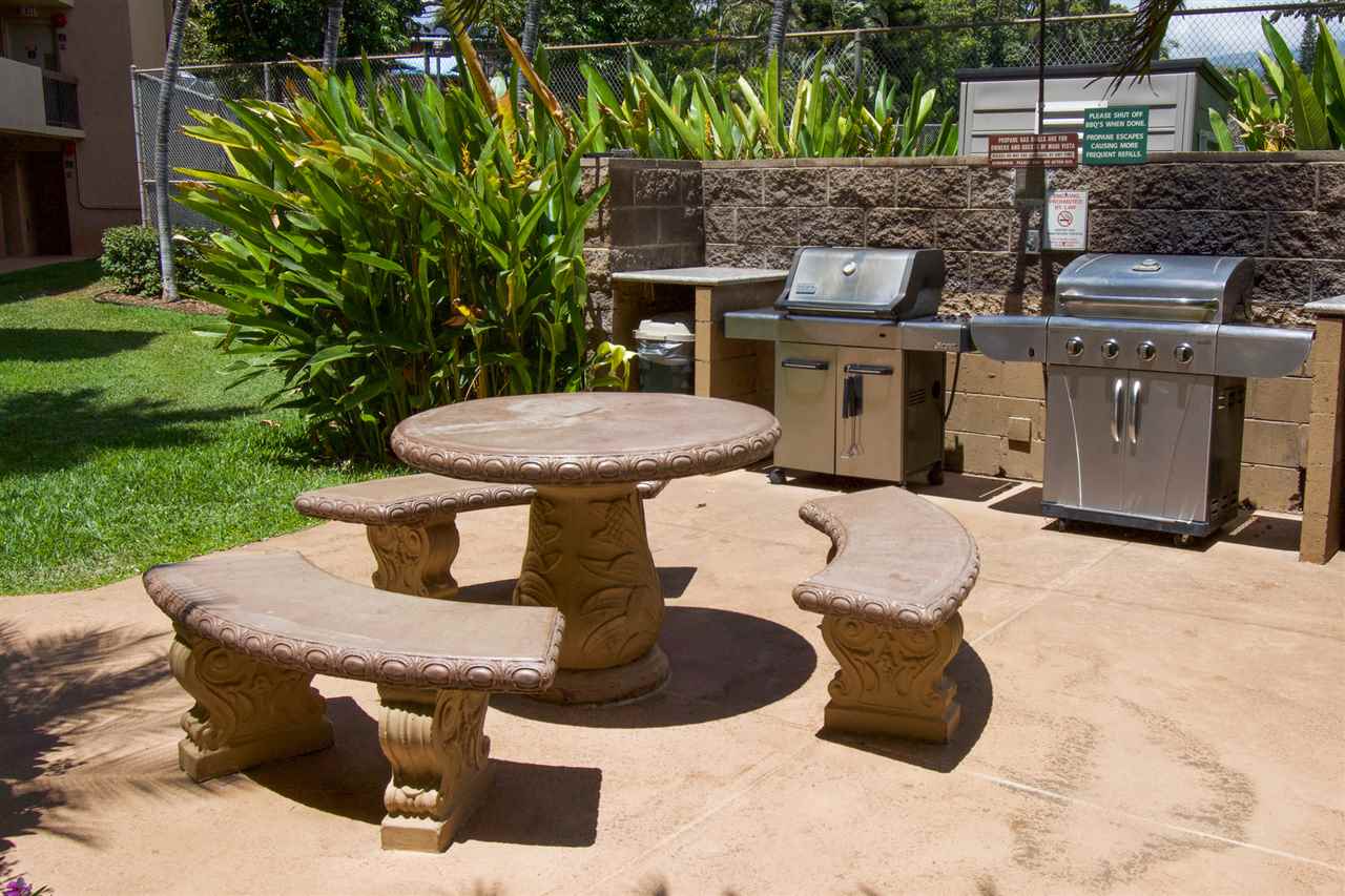 2191 South Kihei Road, Unit 3419 Kihei, HI 96753 - Photo 27 of 30 a view of a patio with table and chairs potted plants