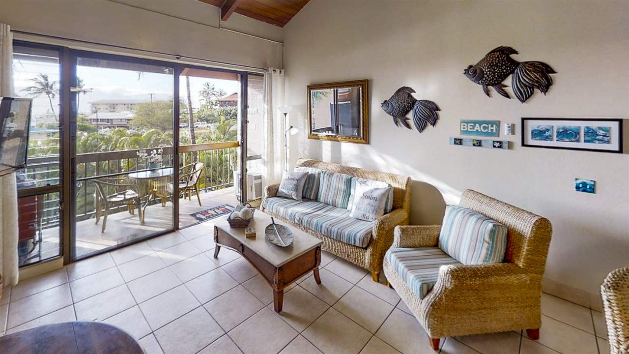 2191 South Kihei Road, Unit 3419 Kihei, HI 96753 - Photo 6 of 30 a living room with furniture and a floor to ceiling window