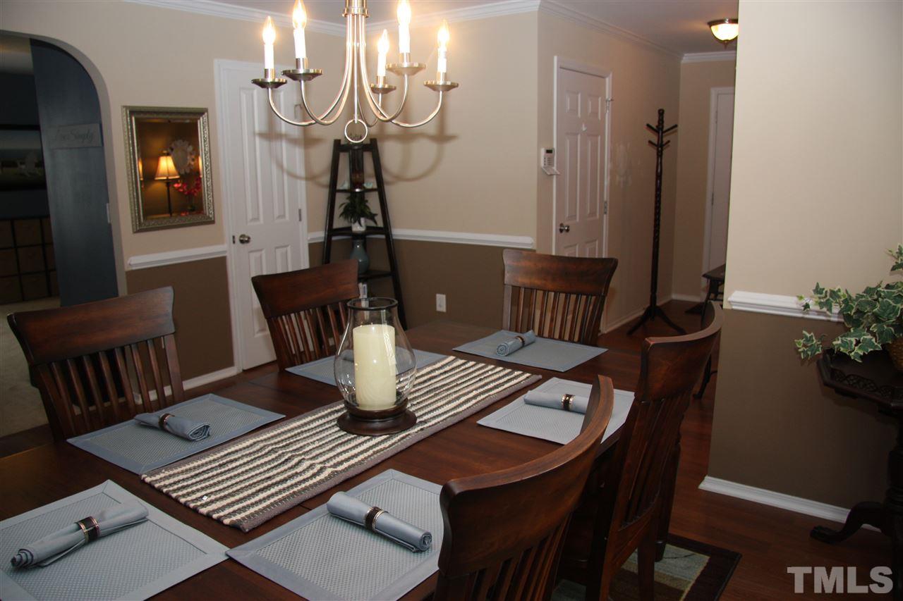 3109 Varcroft Road Knightdale, NC 27545 - Photo 14 of 23 a view of a dining room with furniture and wooden floor