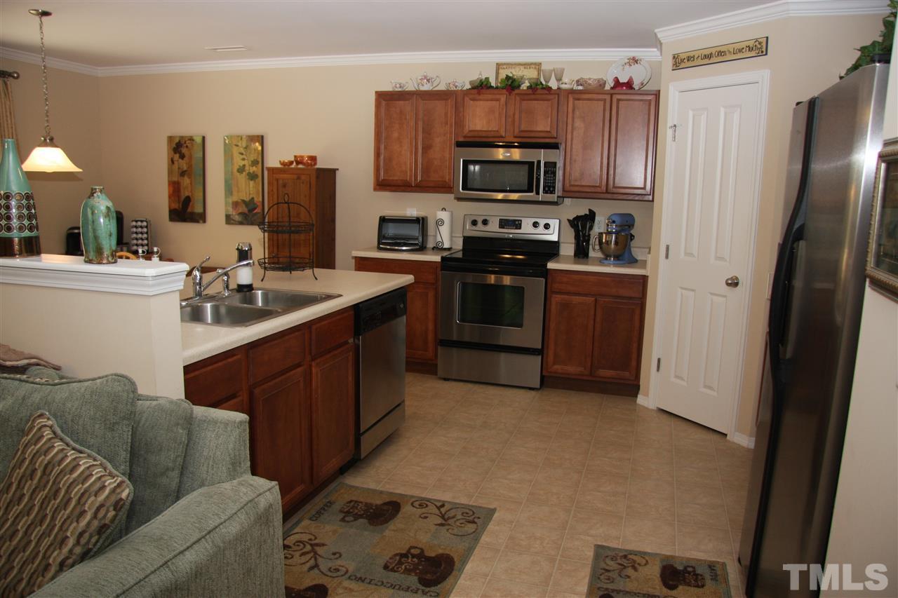 3109 Varcroft Road Knightdale, NC 27545 - Photo 3 of 23 a kitchen with stainless steel appliances granite countertop a refrigerator stove and sink
