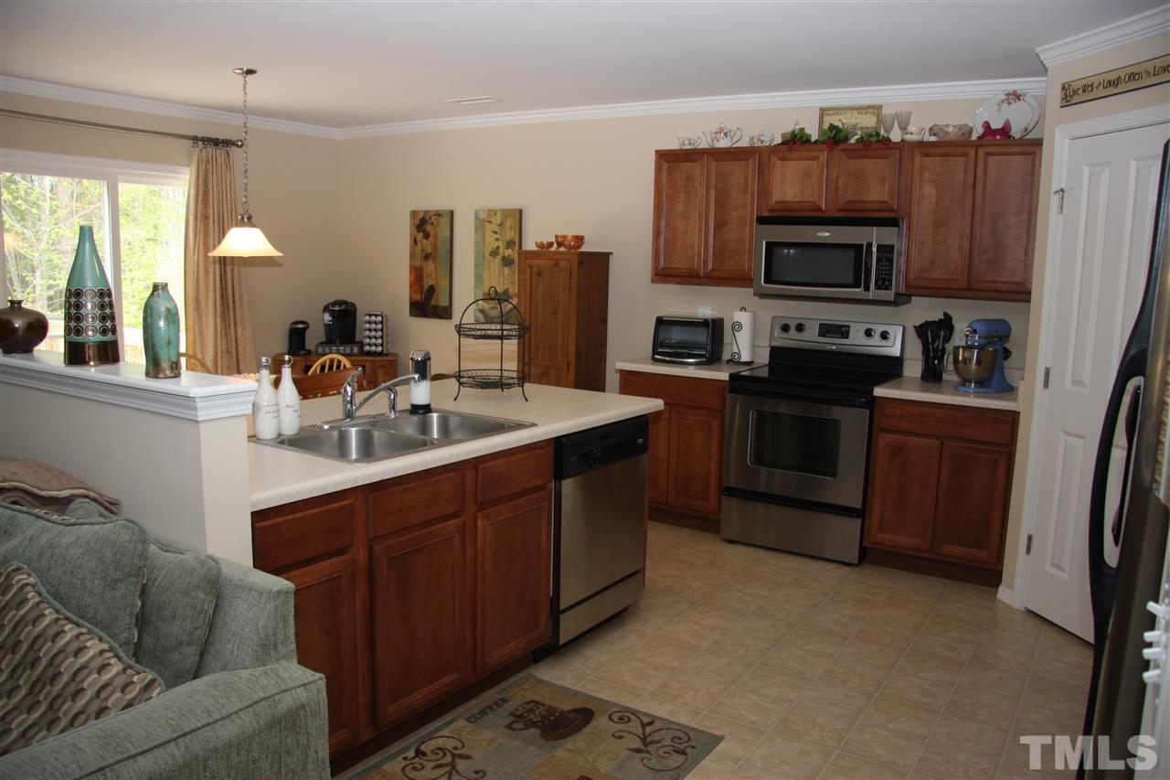 3109 Varcroft Road Knightdale, NC 27545 - Photo 8 of 23 a kitchen with stainless steel appliances a stove sink and microwave