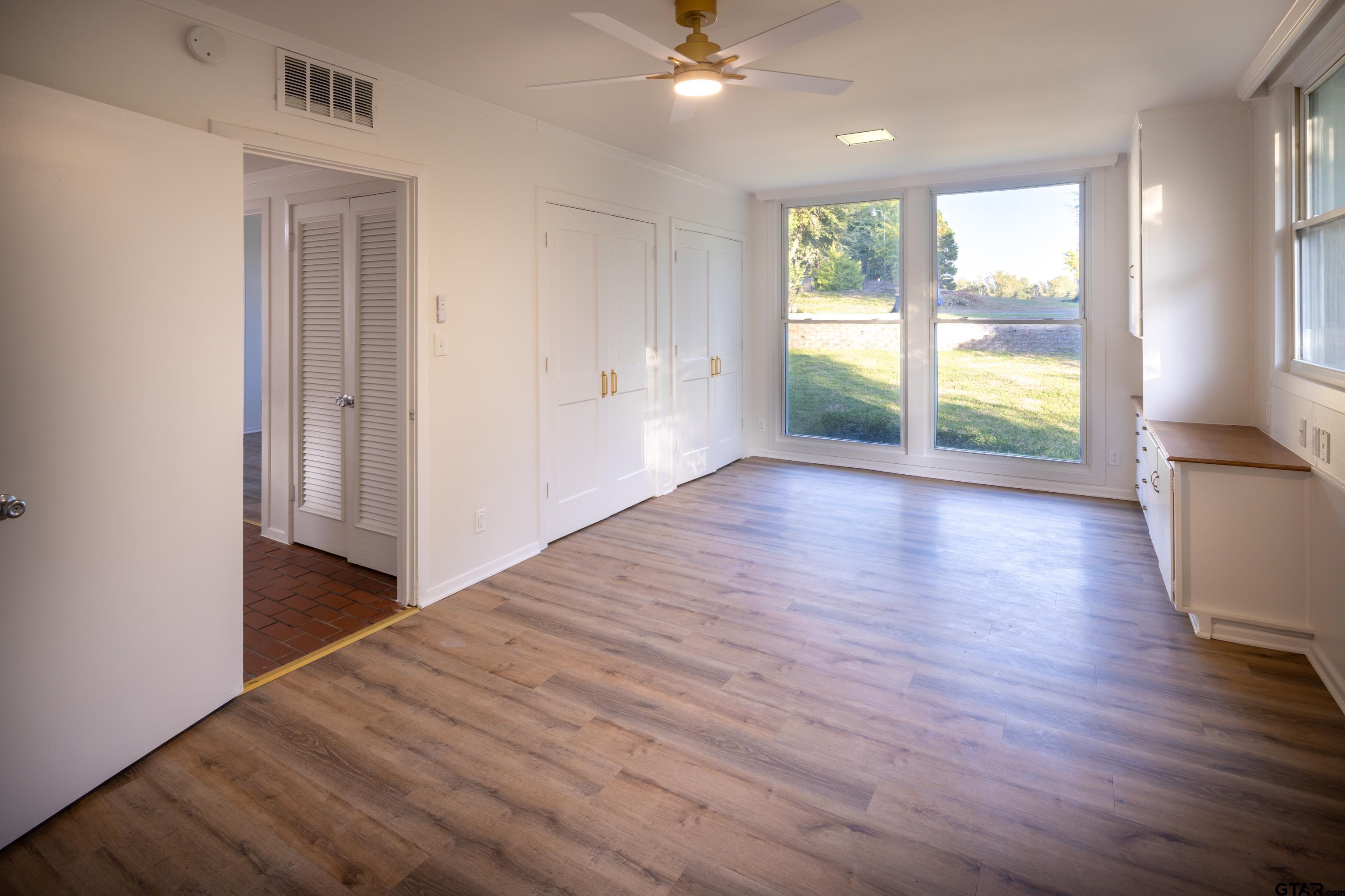 1715 Ridgeview Drive Tyler, TX 75701 - Photo 15 of 35 a view of an empty room with wooden floor and a window