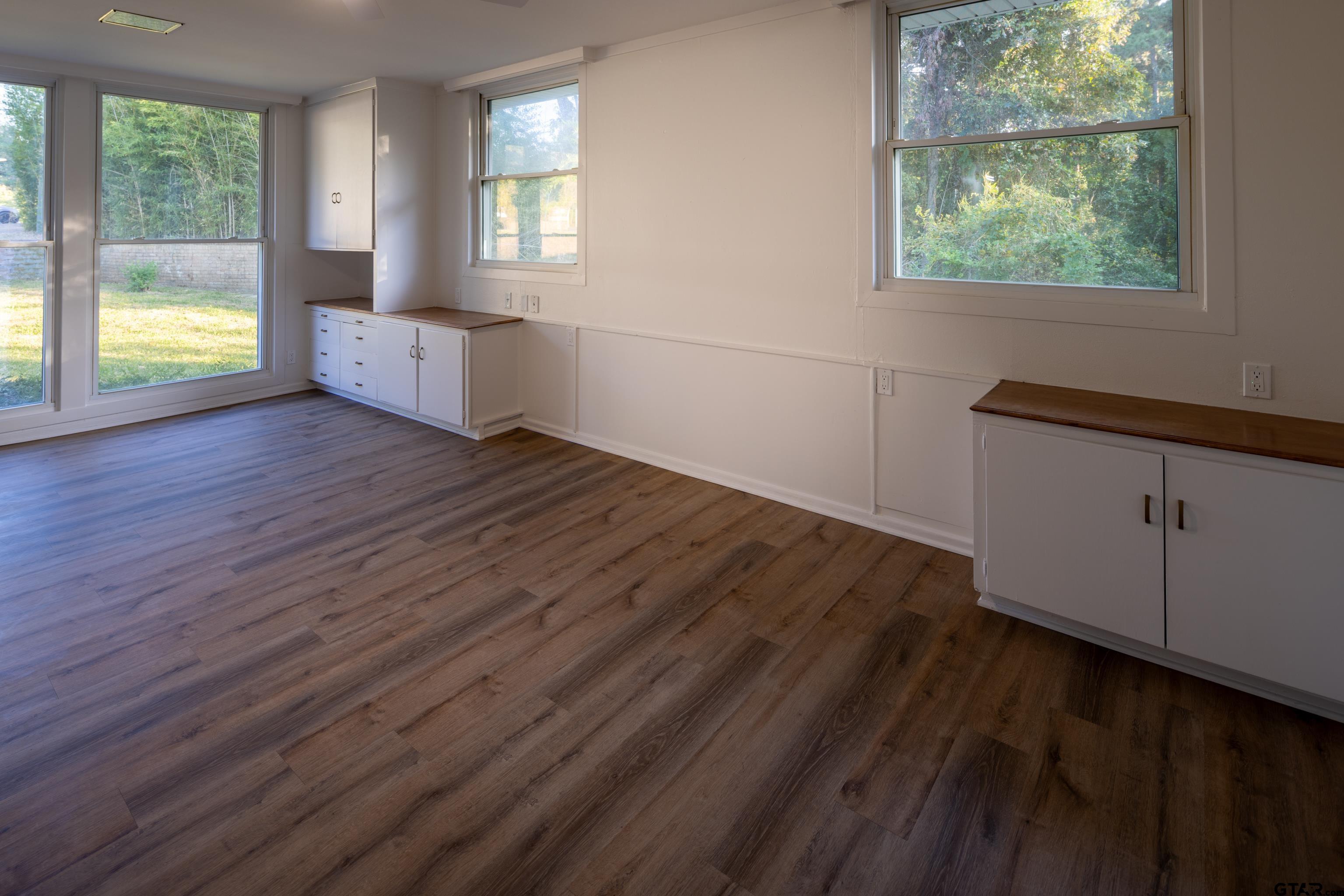 1715 Ridgeview Drive Tyler, TX 75701 - Photo 16 of 35 an empty room with wooden floor and windows