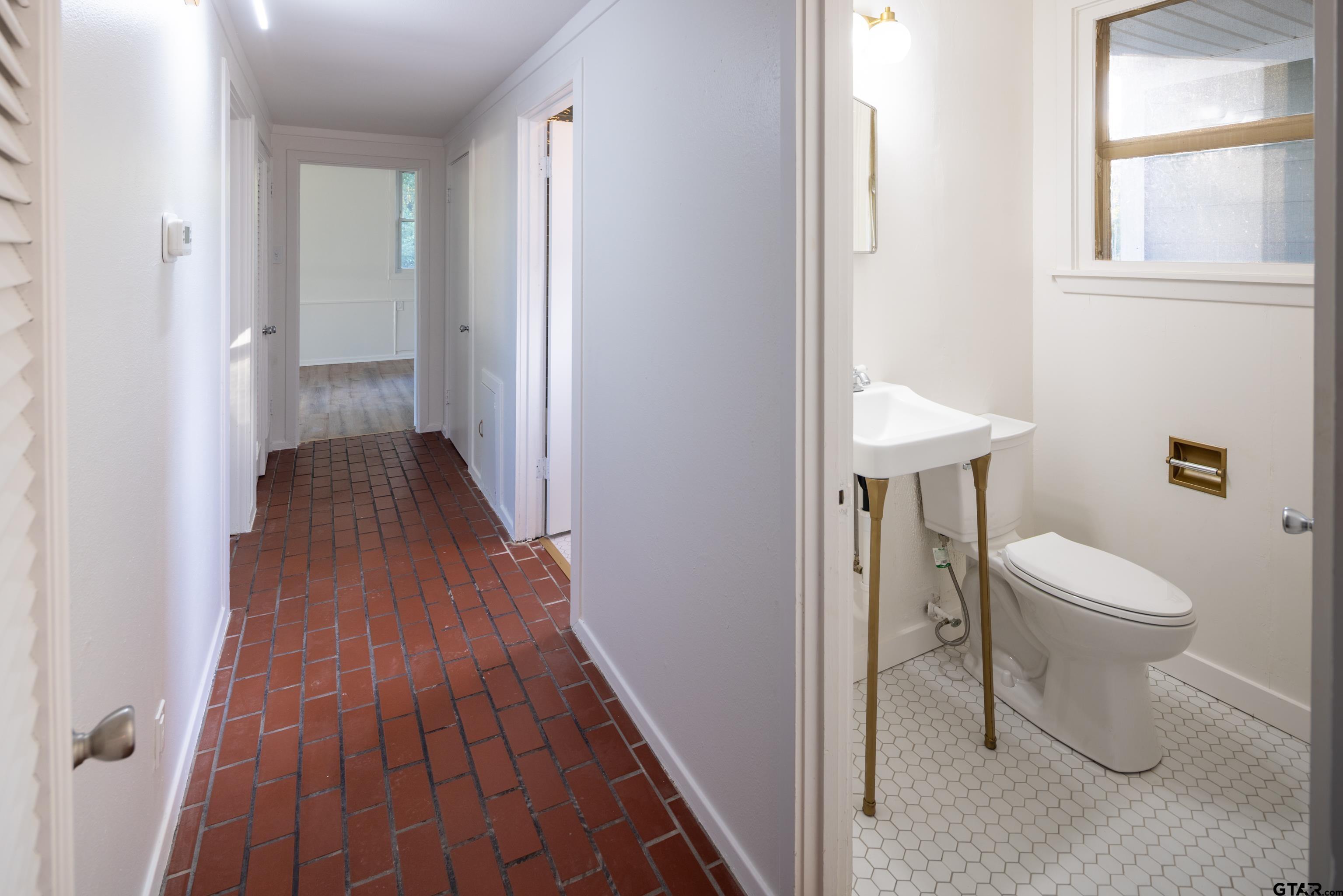 1715 Ridgeview Drive Tyler, TX 75701 - Photo 19 of 35 a view of a bathroom with wooden floor and toilet