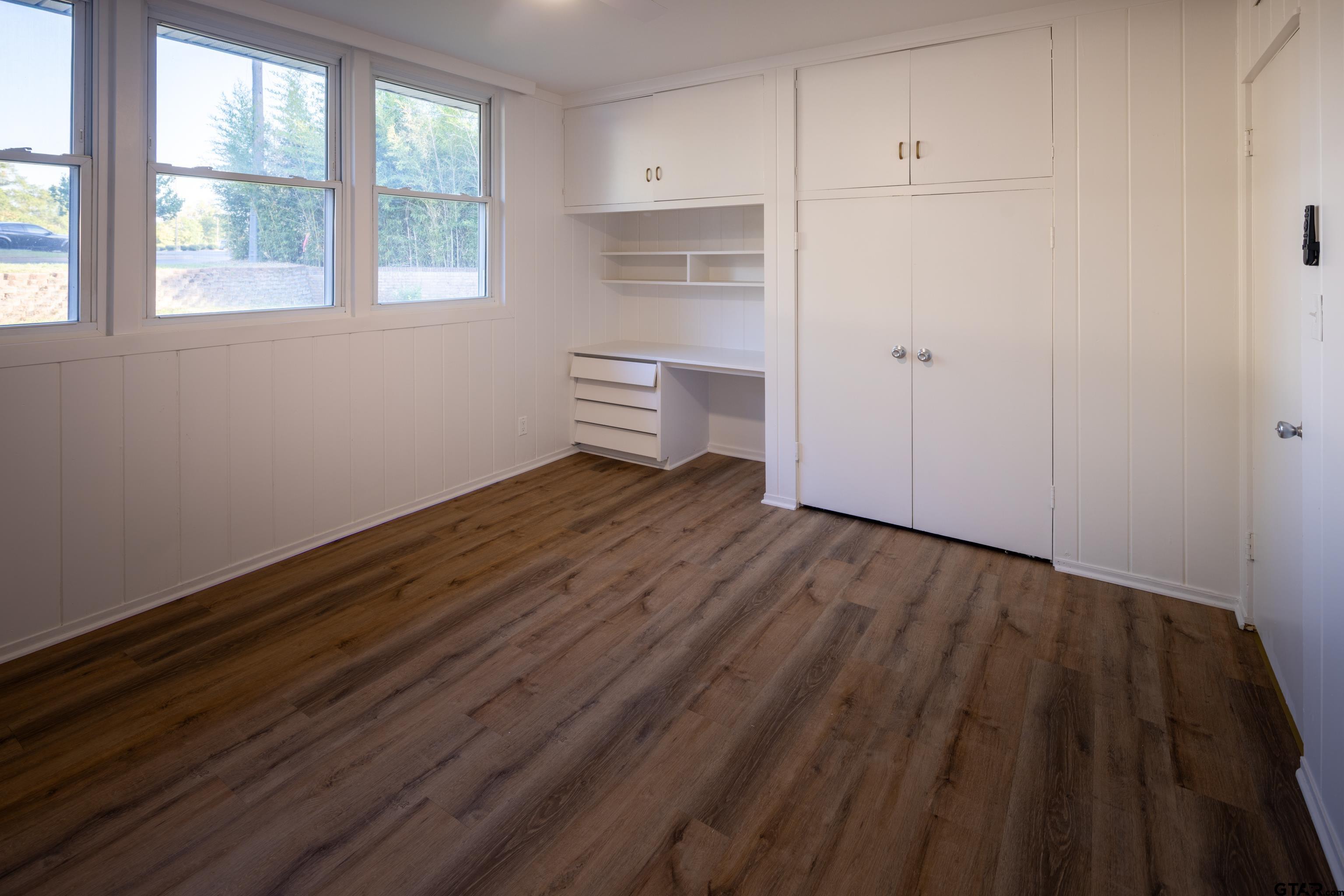 1715 Ridgeview Drive Tyler, TX 75701 - Photo 20 of 35 a room with wooden floor and window