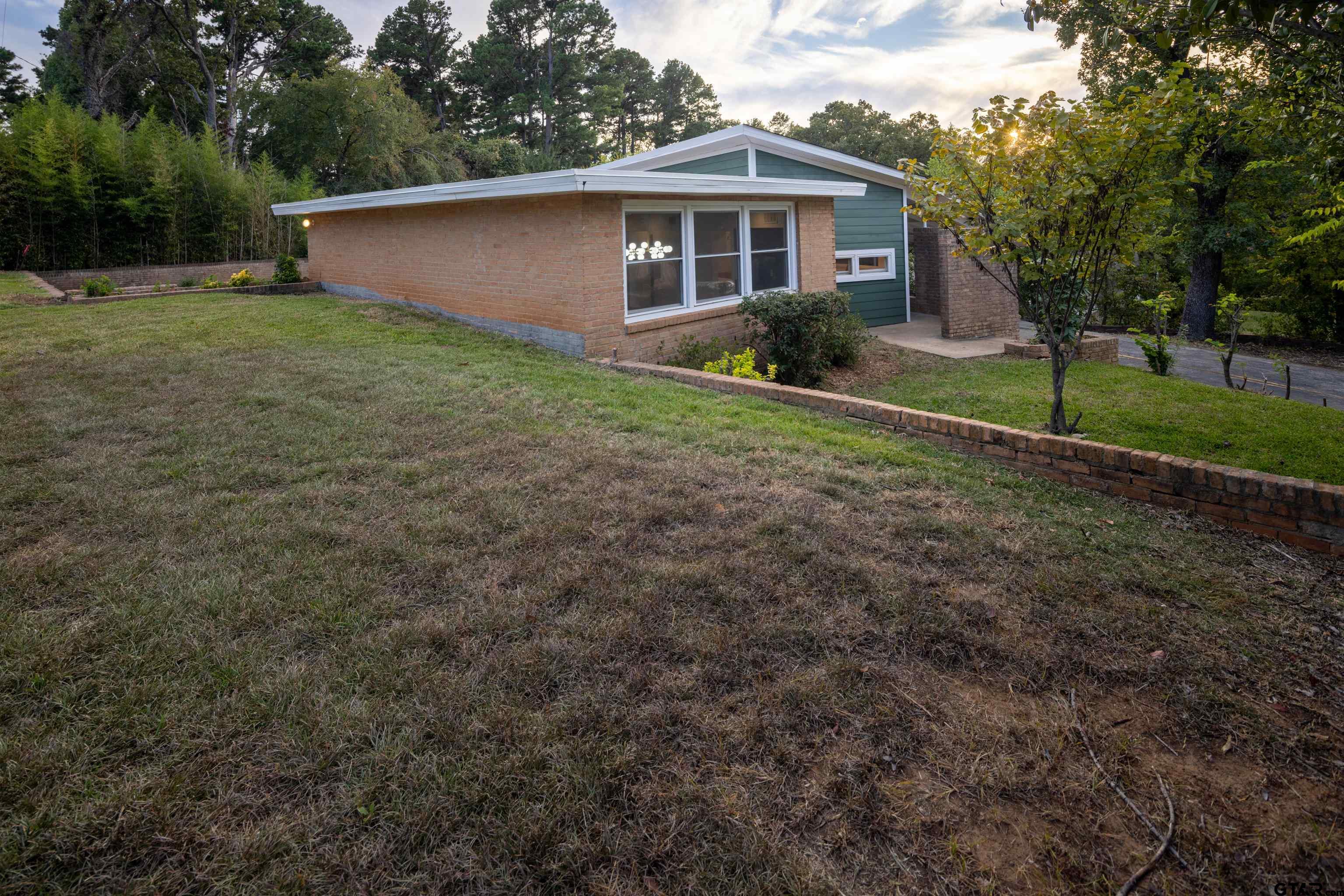 1715 Ridgeview Drive Tyler, TX 75701 - Photo 27 of 35 a view of a yard in front of a house with large trees