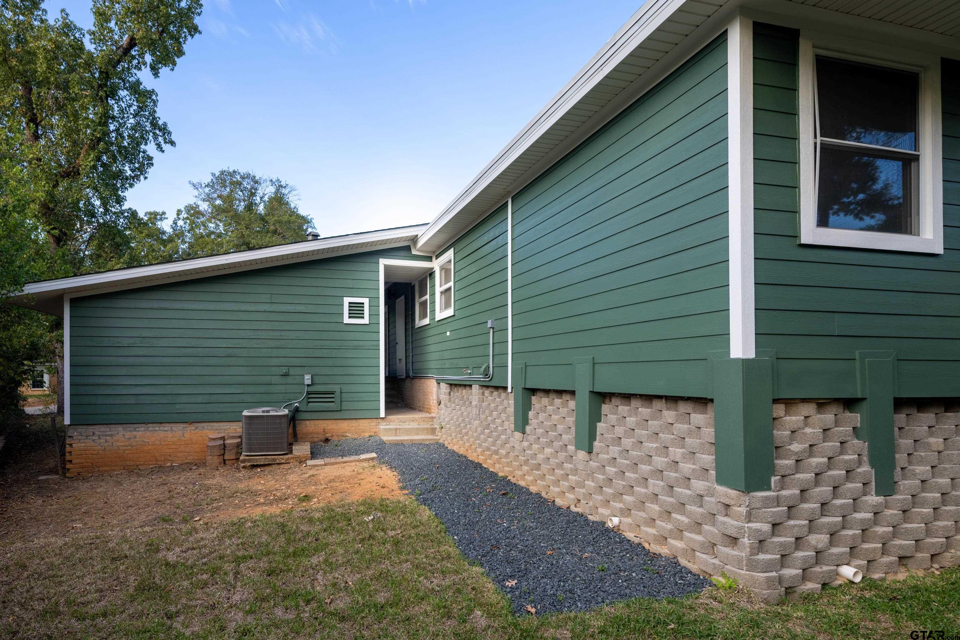 1715 Ridgeview Drive Tyler, TX 75701 - Photo 28 of 35 a view of a small house with yard and garage