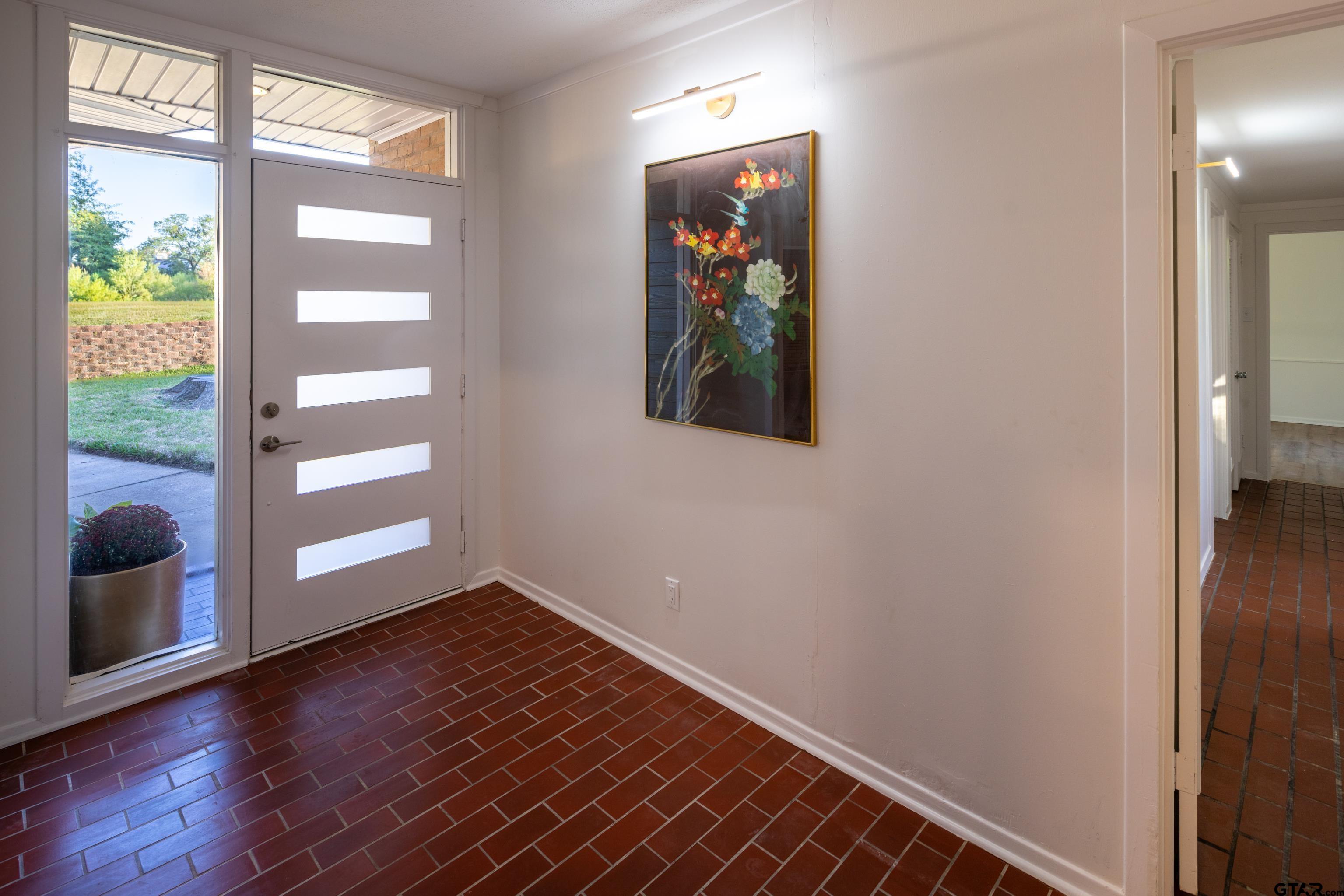 1715 Ridgeview Drive Tyler, TX 75701 - Photo 5 of 35 an empty room with wooden floor and windows