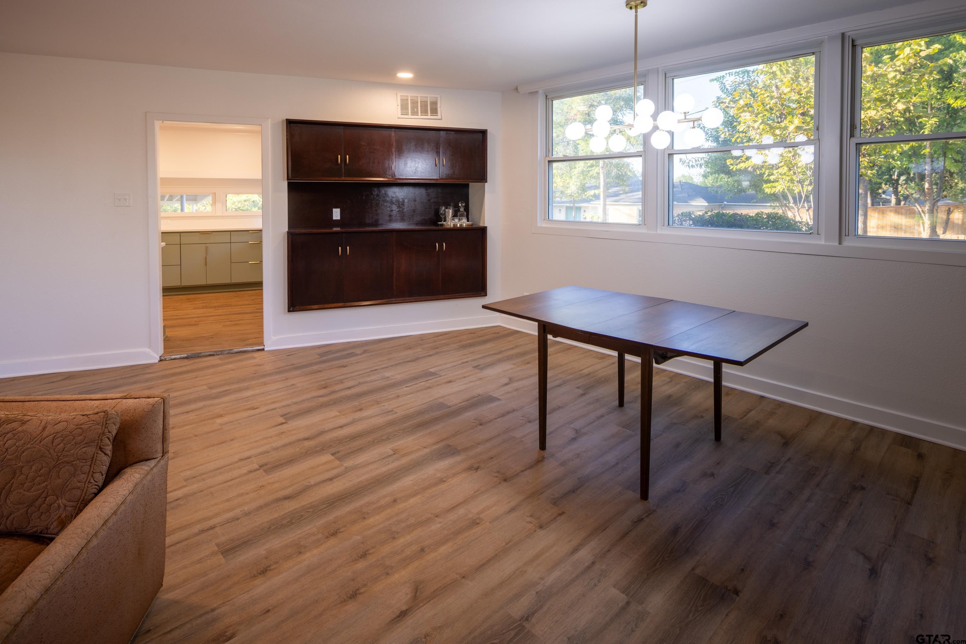 1715 Ridgeview Drive Tyler, TX 75701 - Photo 9 of 35 a living room with hard wood floors and a flat screen tv