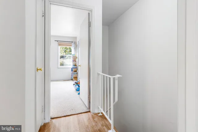 a view of a hallway with wooden floor and entryway
