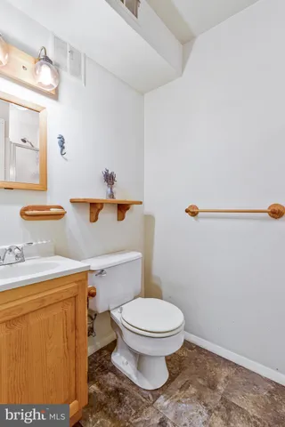 a white toilet sitting next to a bathroom sink