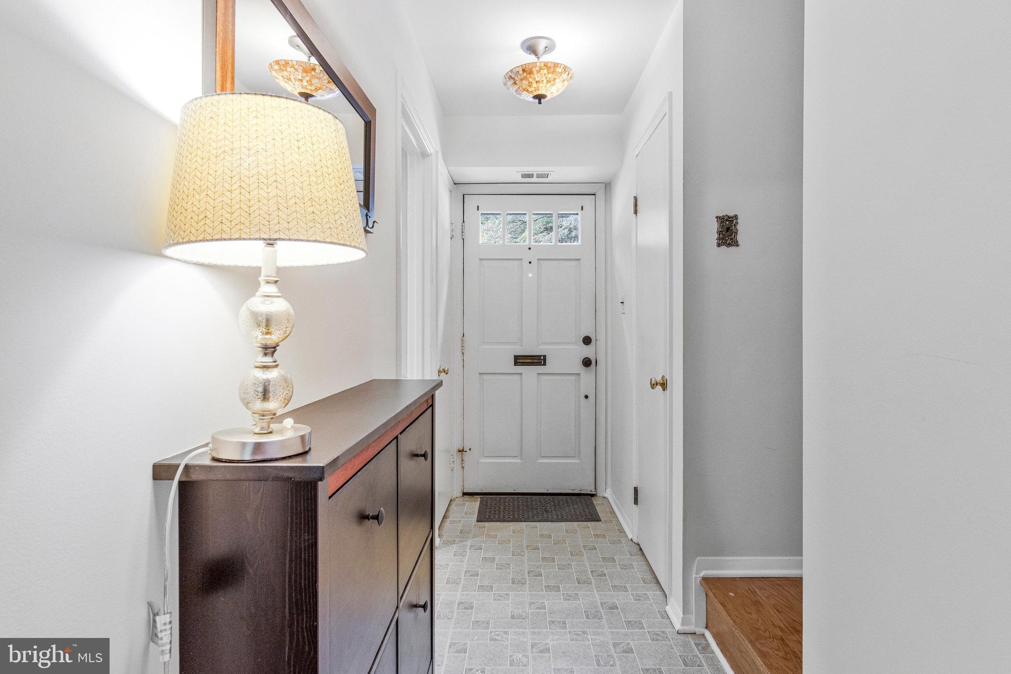 6513 Orono Court Springfield, VA 22152 - Photo 9 of 45 a view of a hallway with a flower pot and a mirror