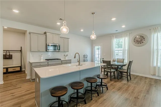 a large kitchen with a table and chairs