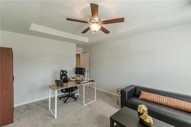 a work room with furniture and a ceiling fan
