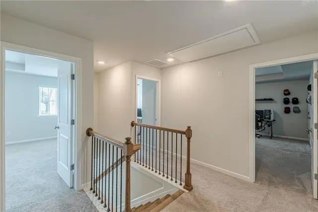a view of a hallway with entryway and stairs