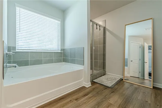 a bathroom with a bathtub and a shower