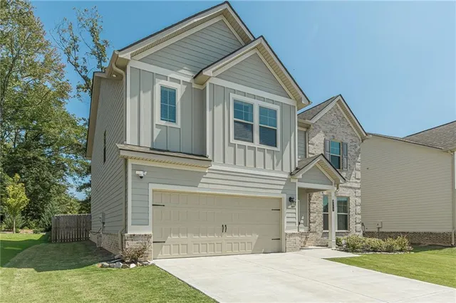 a front view of a house with garden