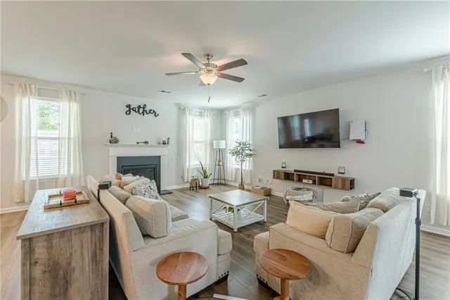 a living room with furniture a fireplace and a flat screen tv