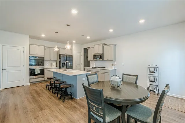 a view of a dining room with furniture and wooden floor