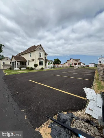 a room with lots of wooden furniture and a view of living room