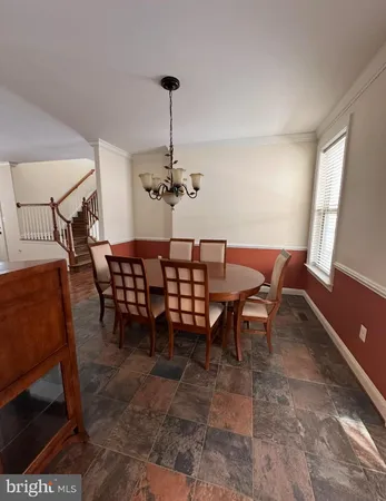 a view of entryway with wooden floor and stairs
