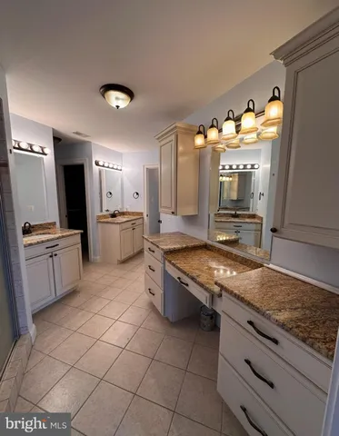 a view of empty room with wooden floor and window