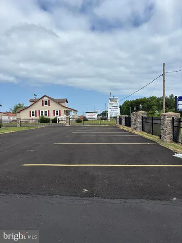 a front view of a house with a garden and yard