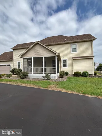 a view of a house with a yard and sitting area